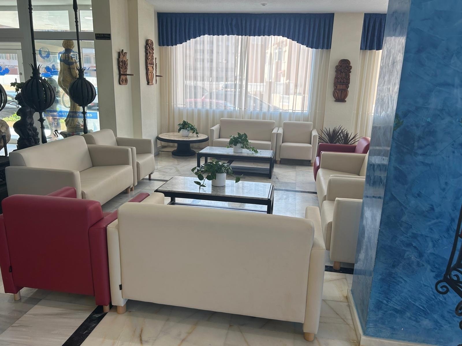 a living room with a blue wall and a sign that says ' a ' on it