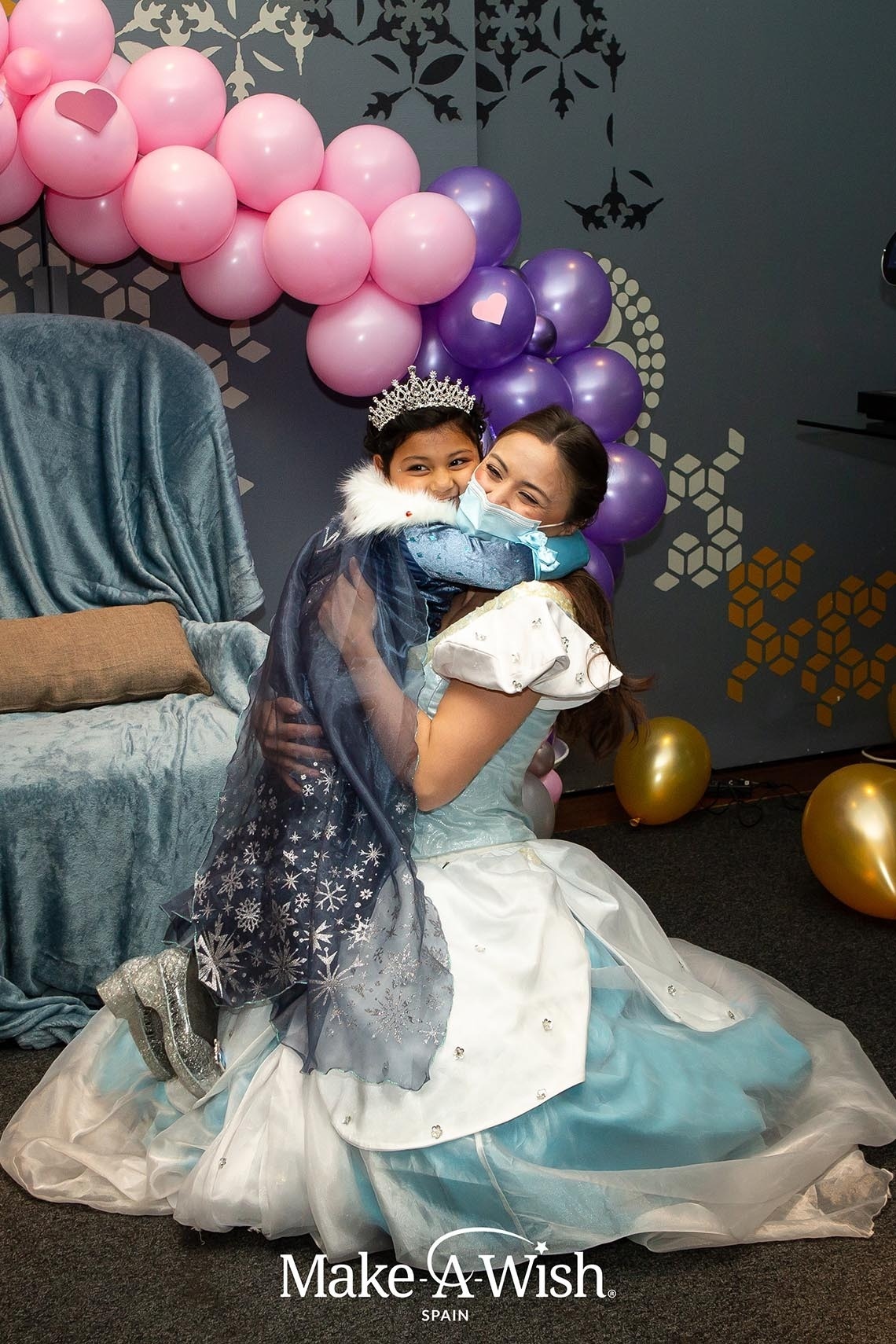 a make a wish spain photo of a princess hugging a little girl