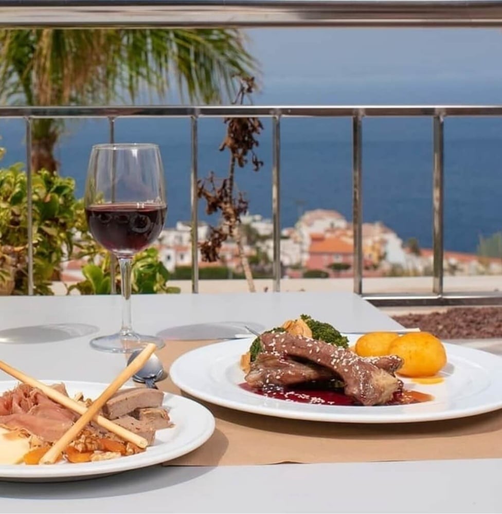 Landmar dining experience: gourmet meal with sea views and wine.