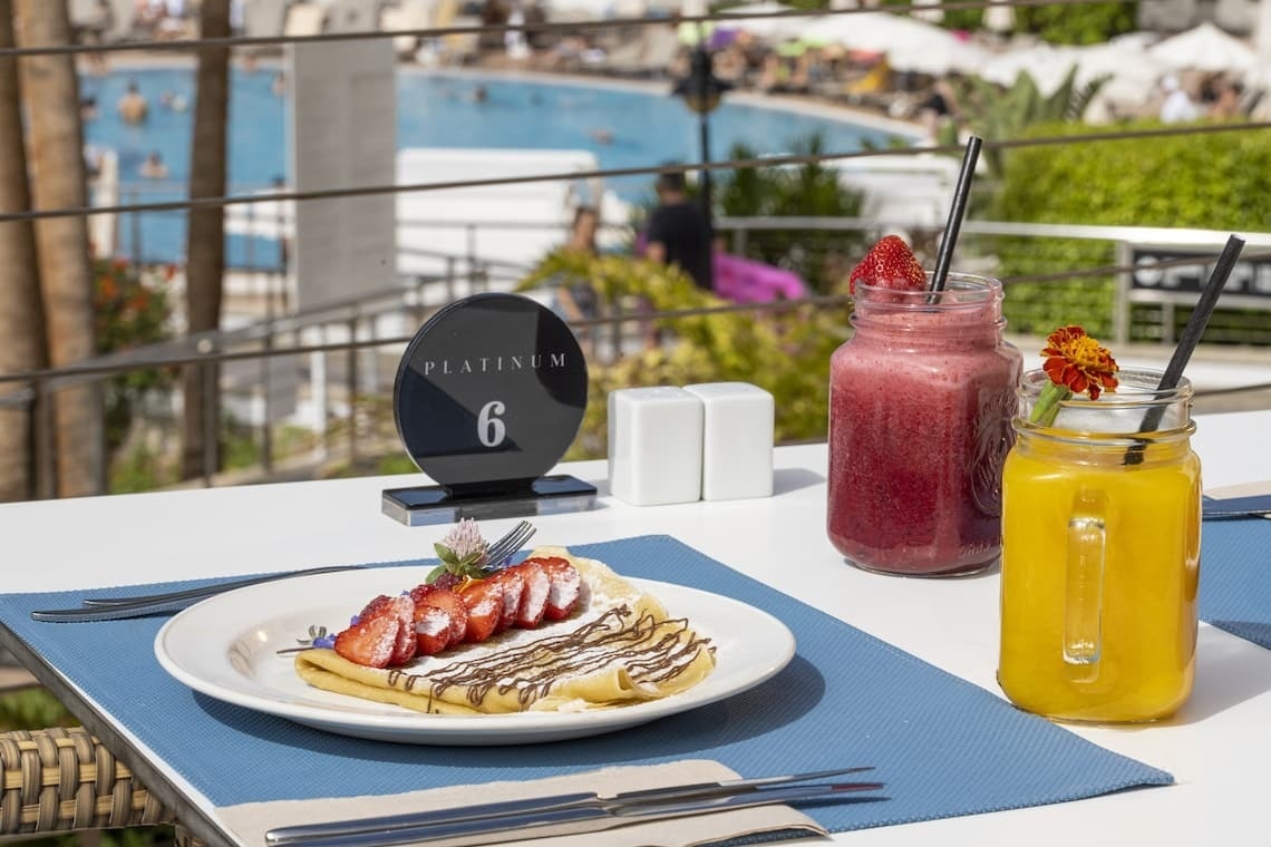 a plate of food sits on a table next to a platinum sign