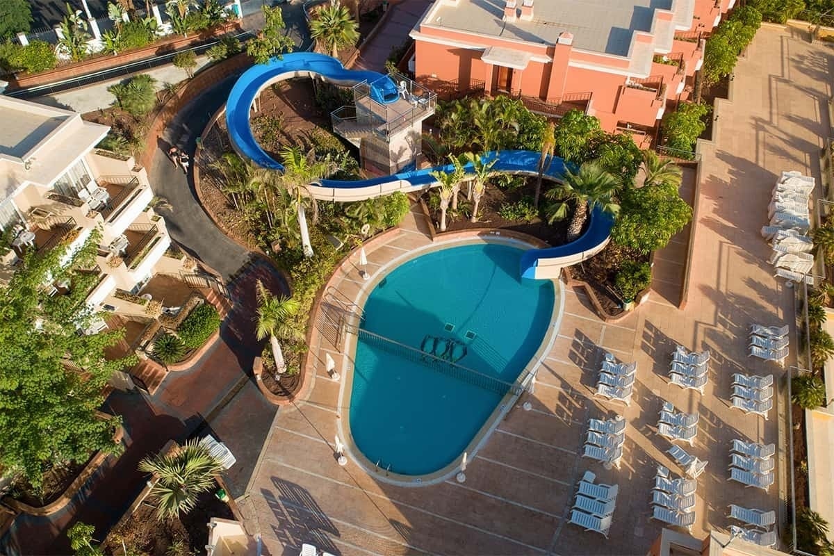 an aerial view of a swimming pool with a water slide