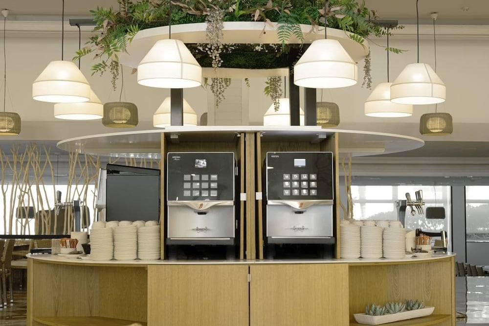 two coffee machines with one that says ' jacobs ' on it