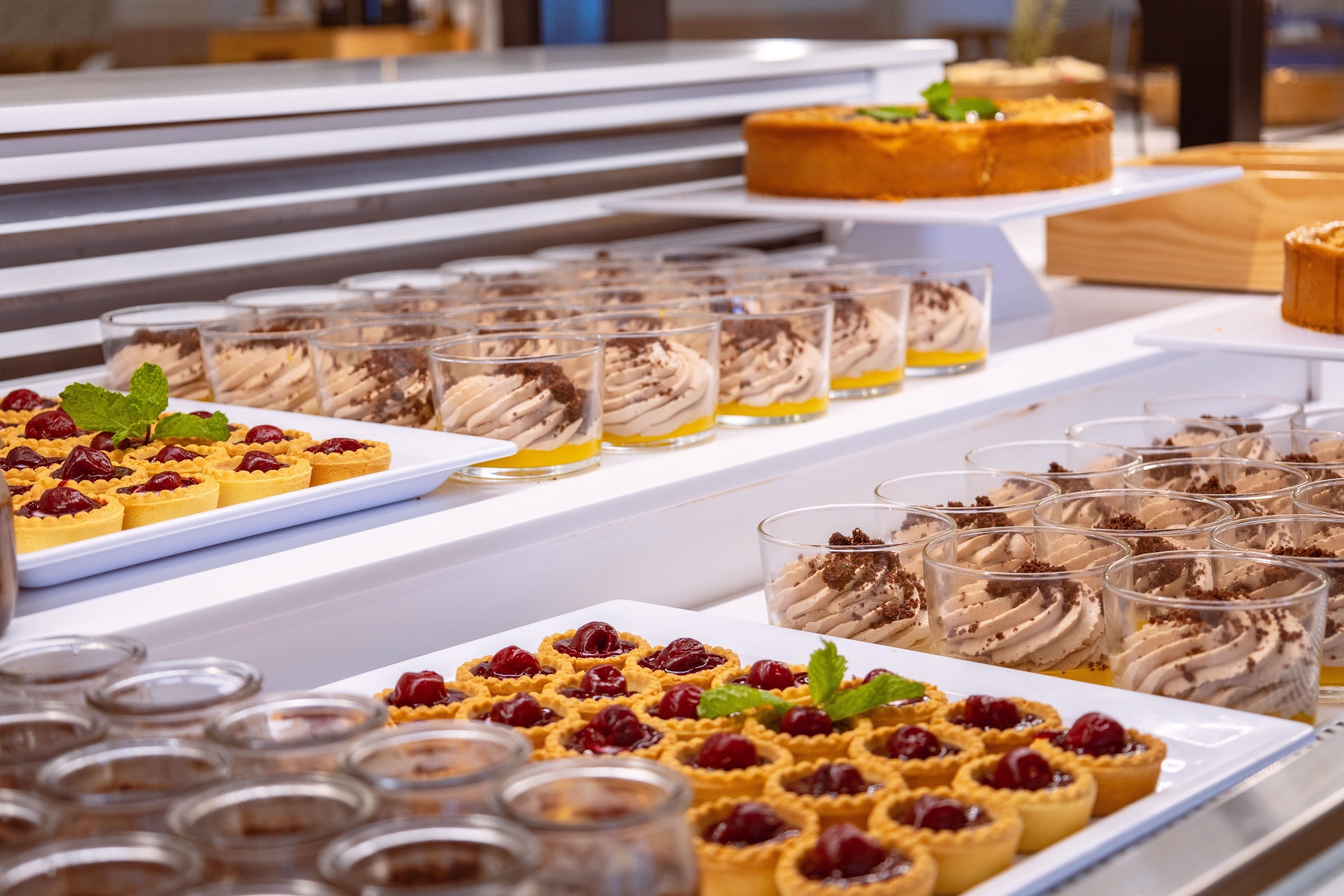 a variety of desserts are displayed on a buffet table
