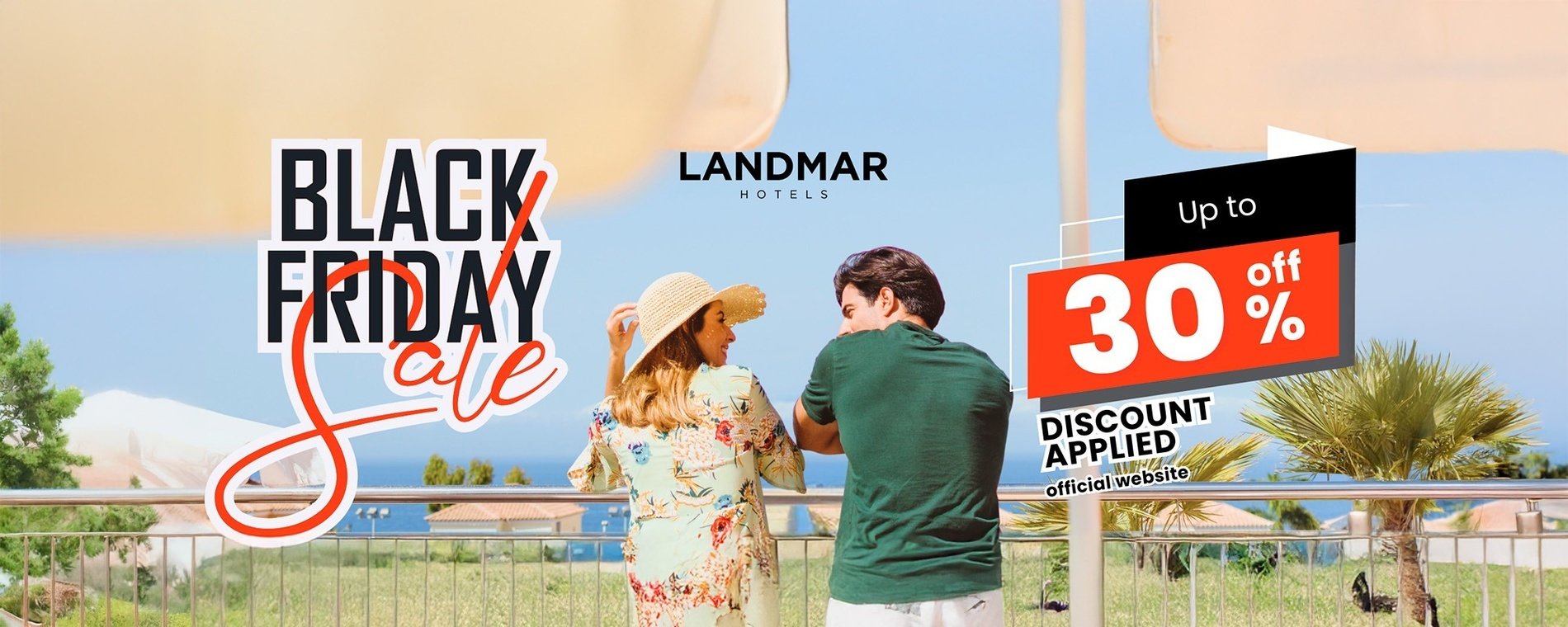 a man and woman standing on a balcony with a sign that says black friday sale