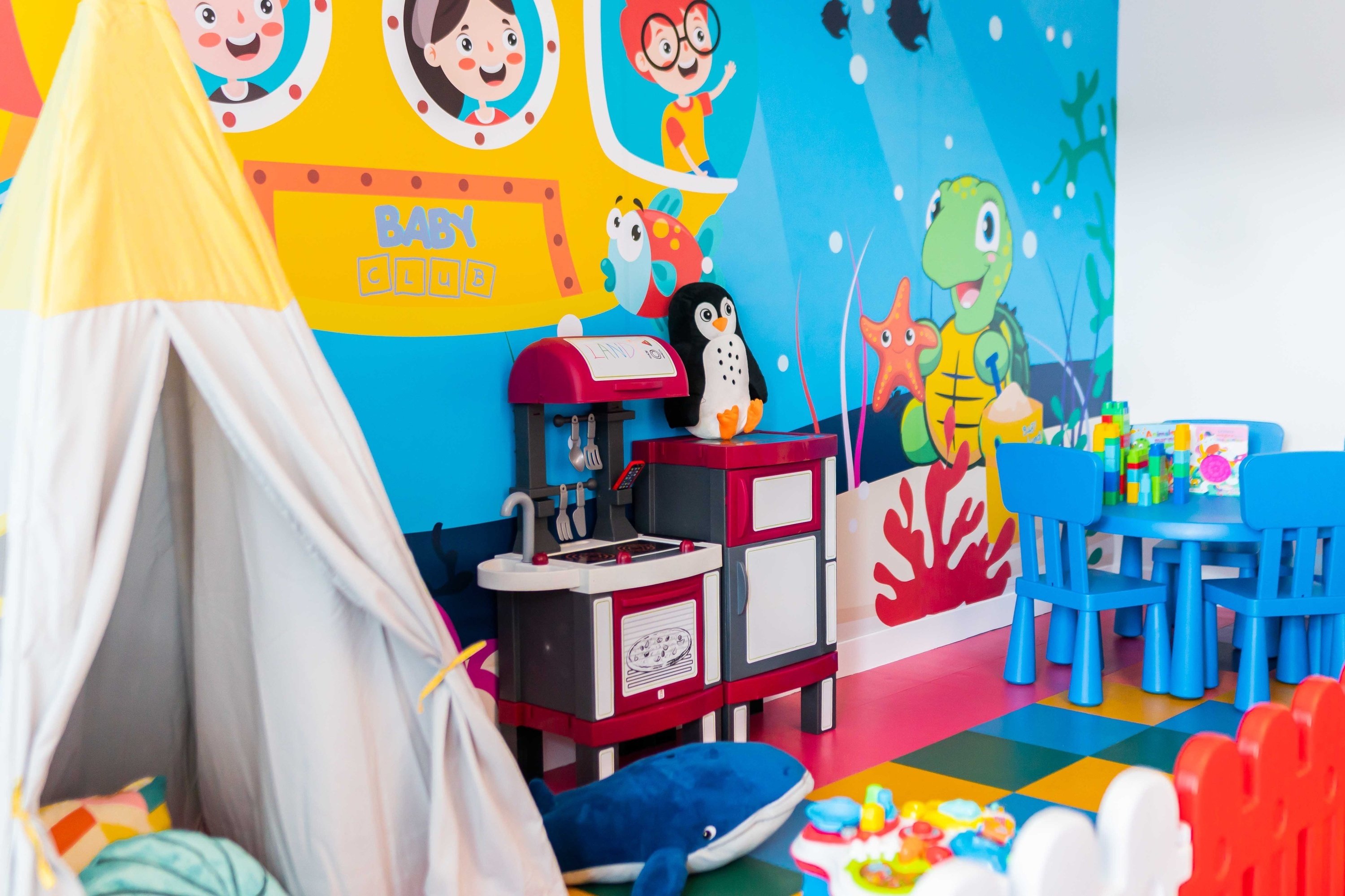 a child 's play room with a sign that says baby food