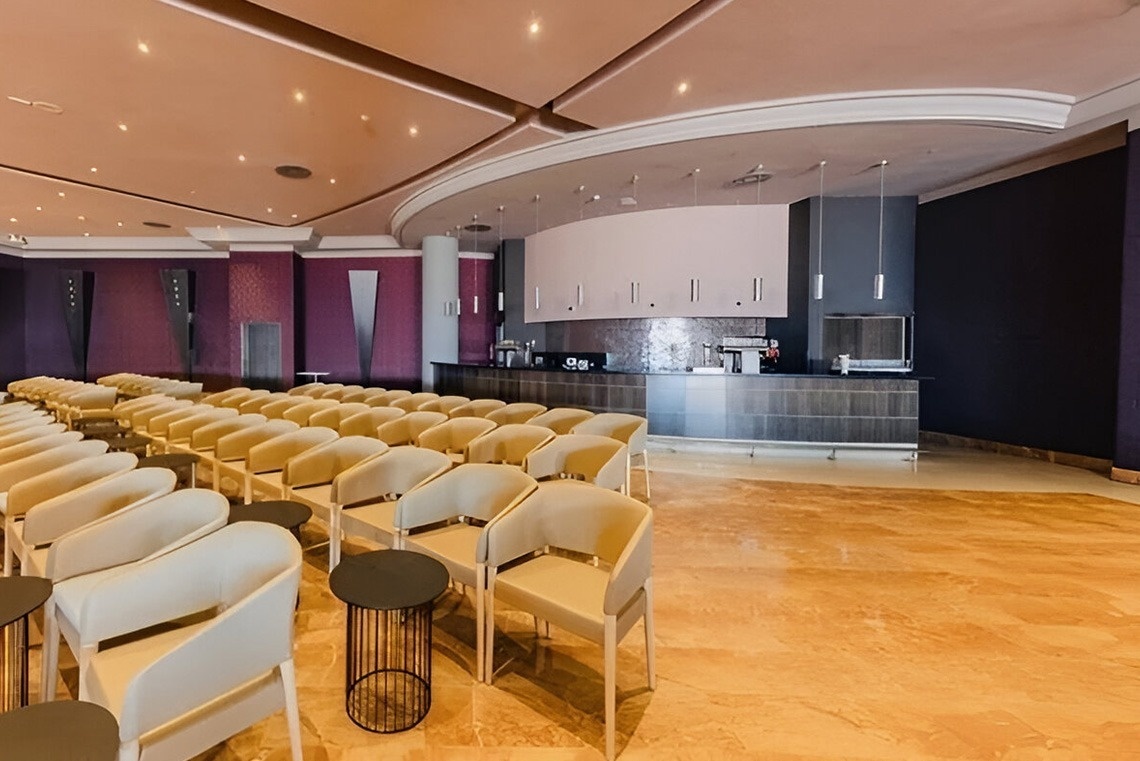 a large room with rows of chairs and a counter