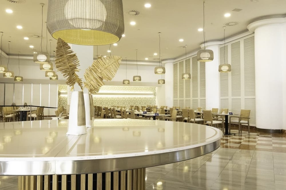 a dining room with tables and chairs and a round table