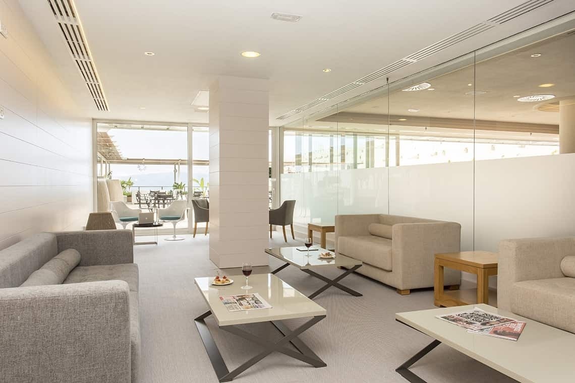 a living room filled with furniture and a table with a magazine on it