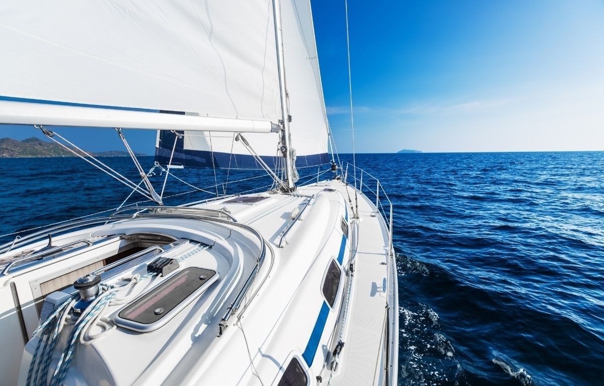 a sailboat is floating in the ocean on a sunny day