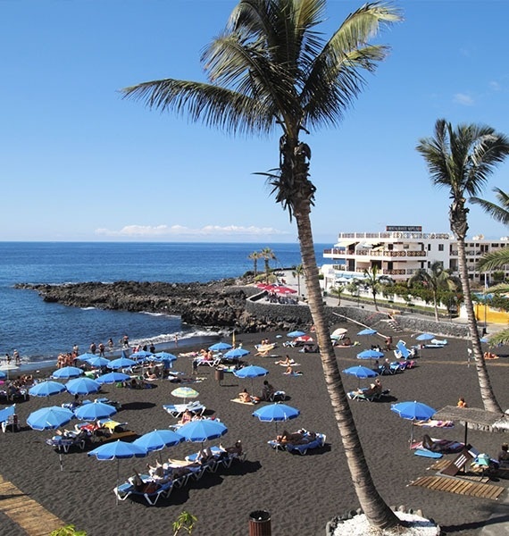 an aerial view of a beach with boats in the water