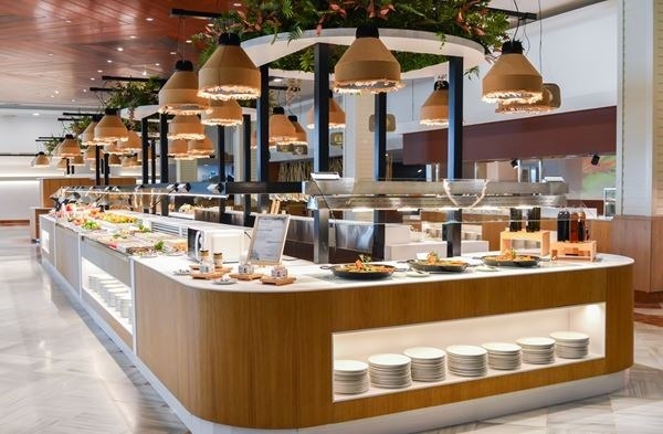 a buffet with a lot of food and plates on display in a restaurant .