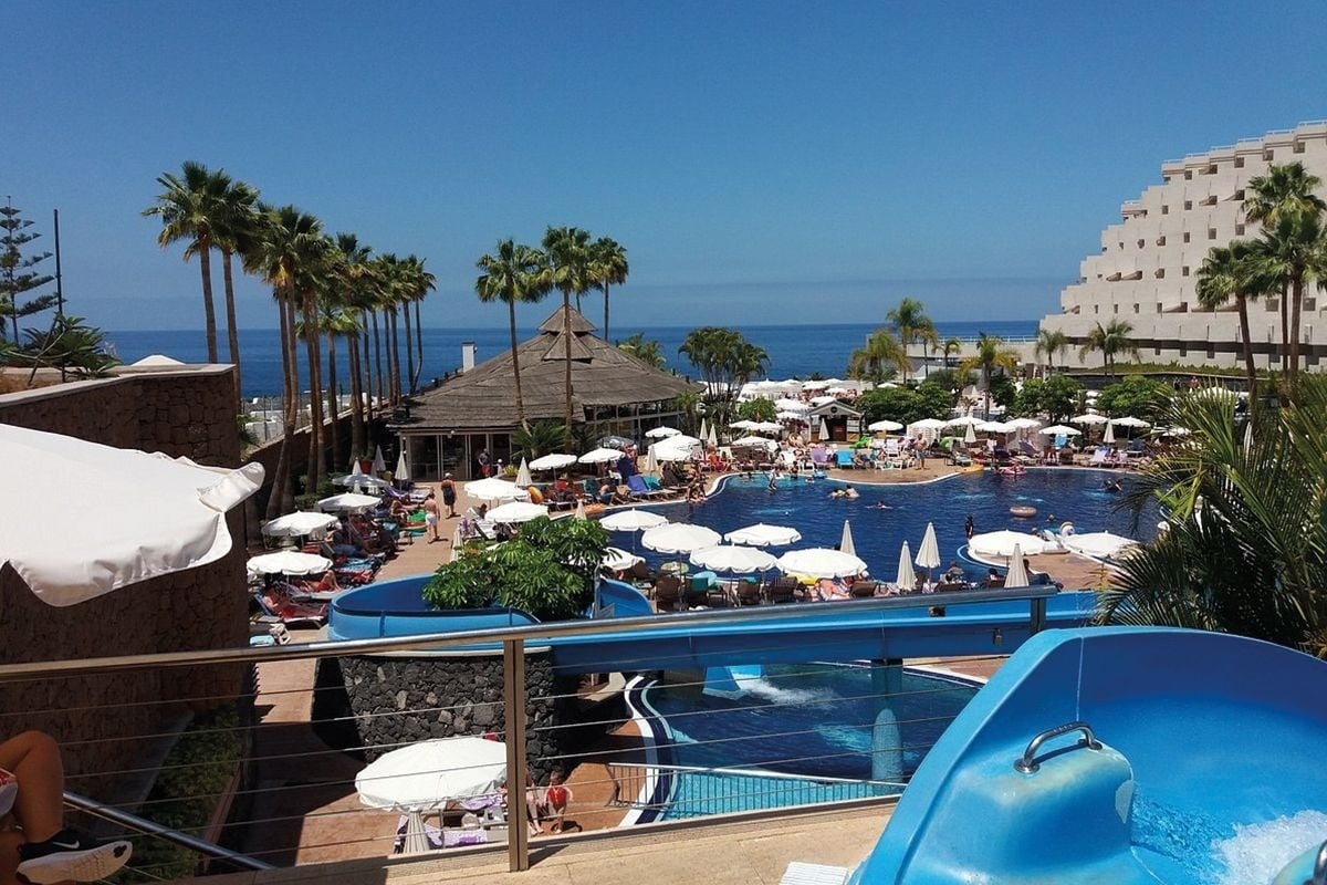 a large swimming pool with a water slide in the middle