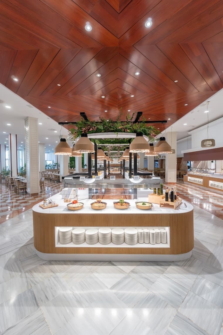 une salle à manger avec un comptoir de nourriture et un plafond en bois