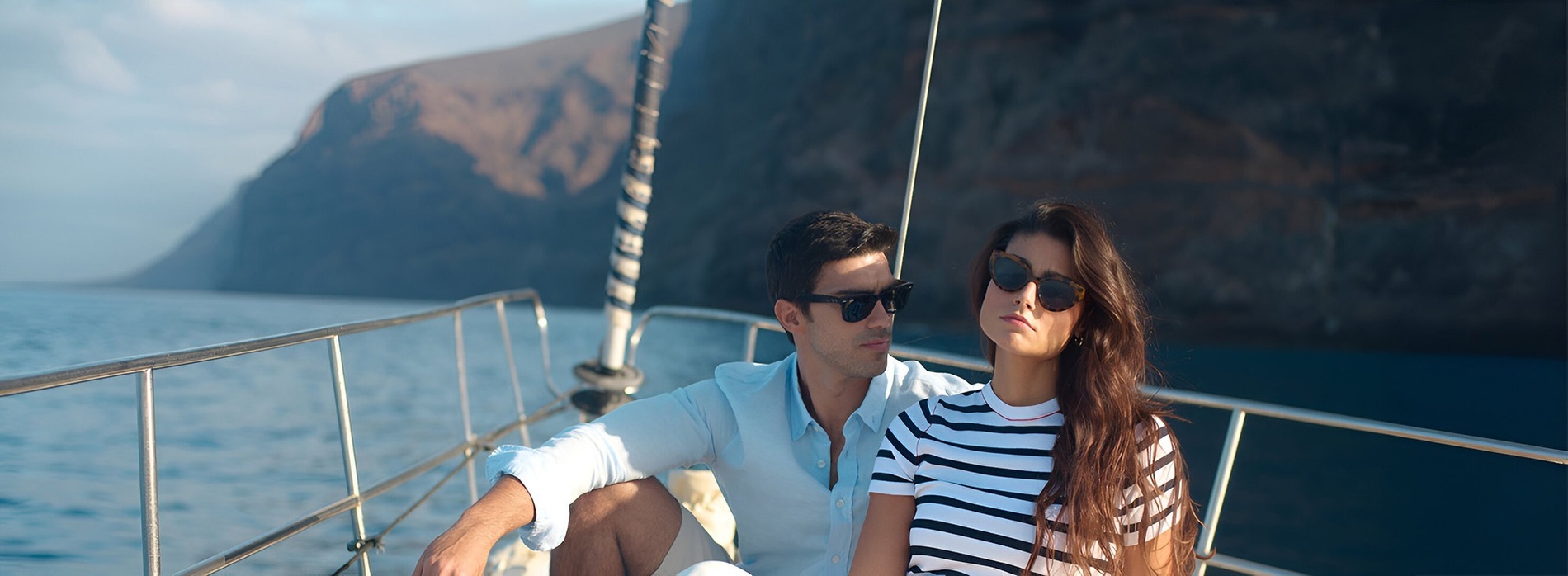 a man is carrying a woman on his shoulders on the beach