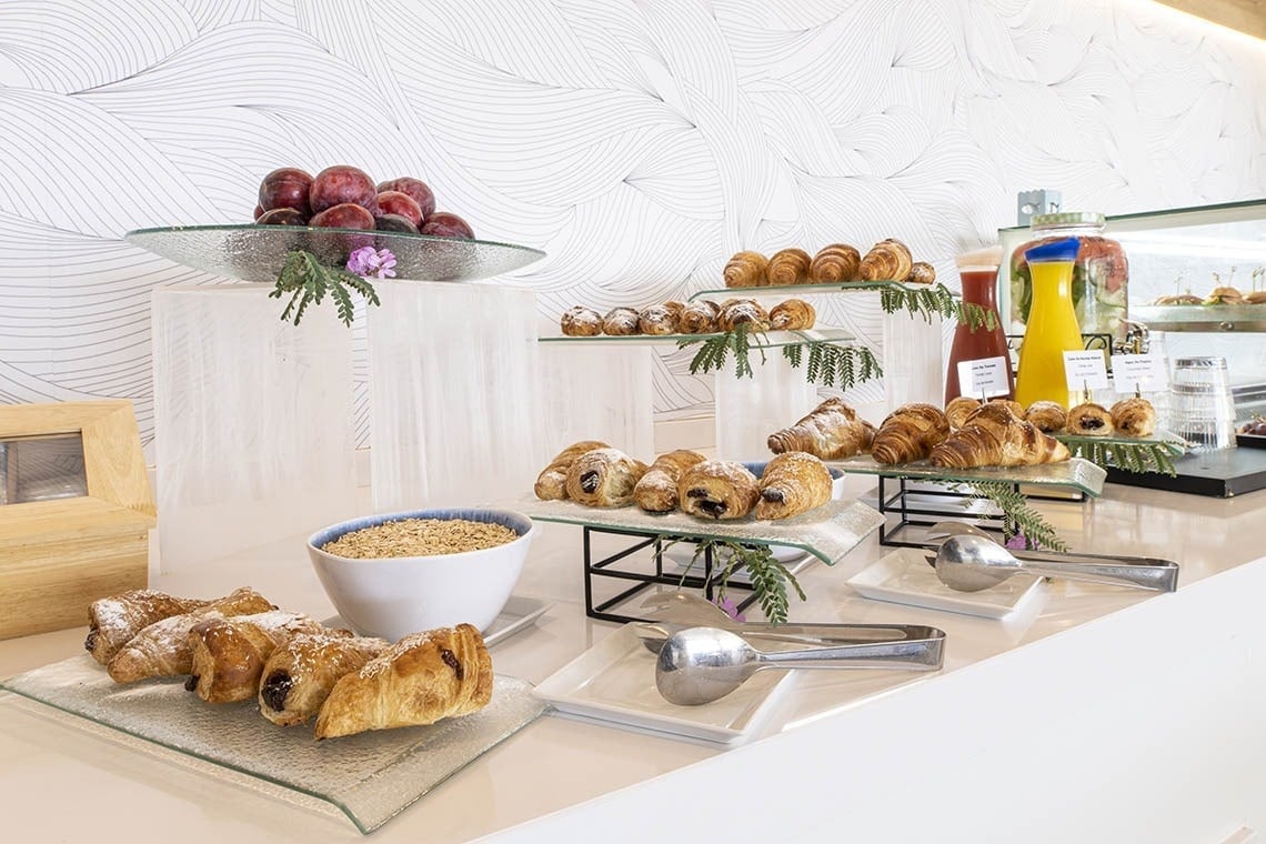 a variety of pastries are on display at a buffet