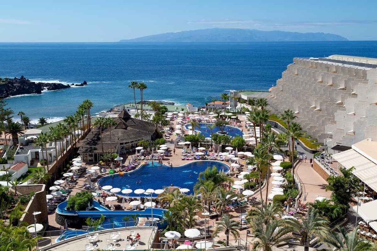 an aerial view of a resort with a large swimming pool