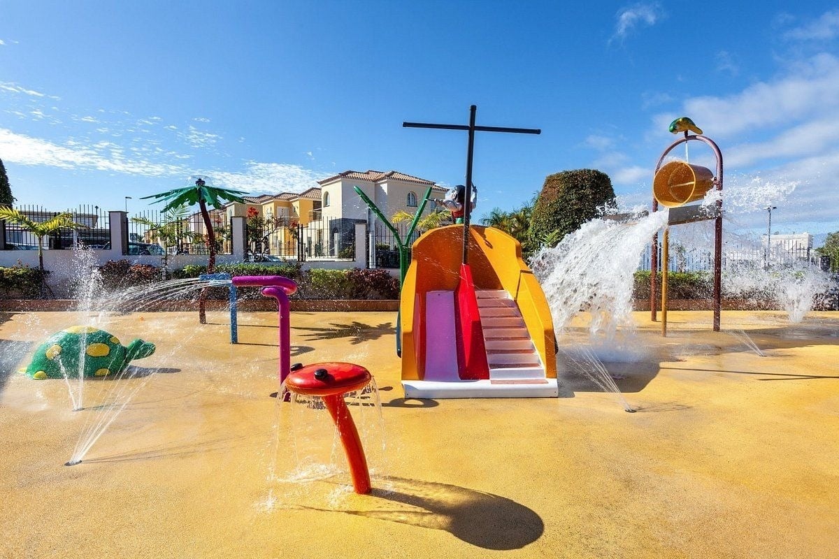 a water park with a slide in the shape of a pirate ship