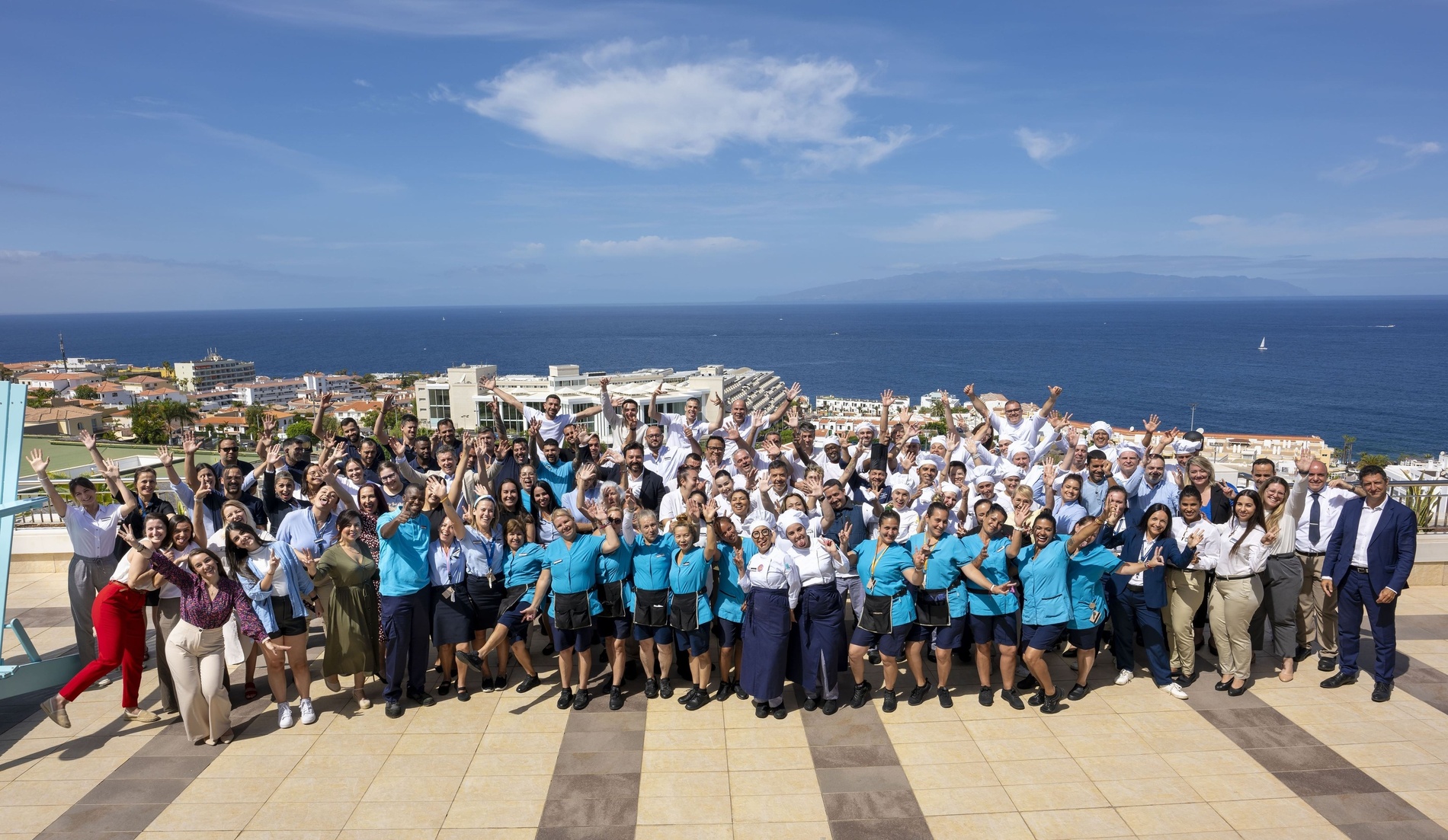 a group of people are sitting around a table shaking hands