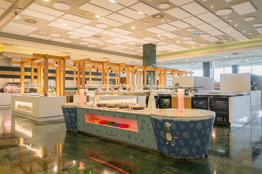 a buffet area in a restaurant with a chef on the counter