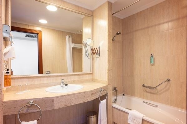 a bed with a zebra print blanket and pillows