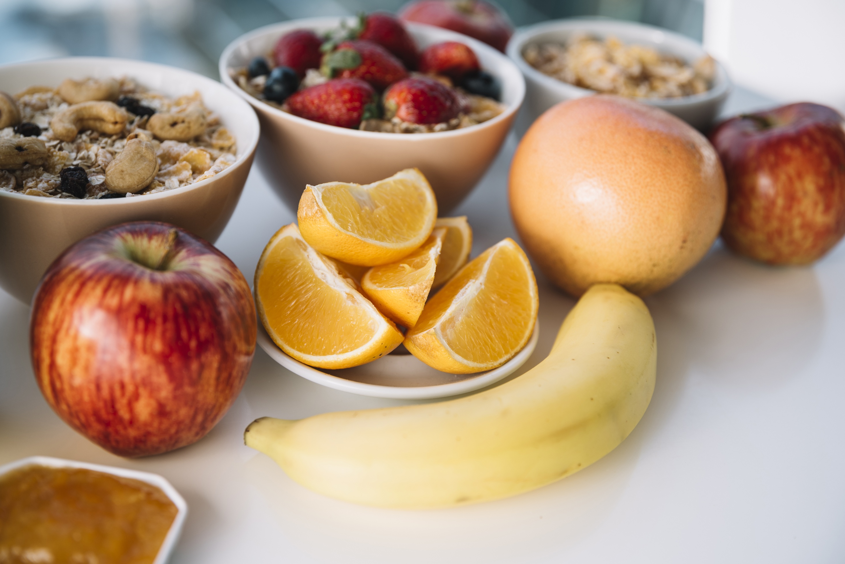 A hotel breakfast spread from Landmar: cereal, fruit, and juice.