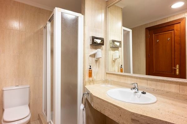 a bed with a zebra print blanket and pillows