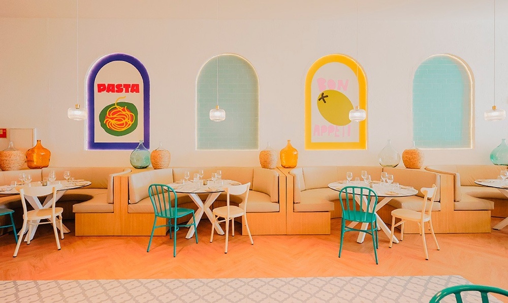 a woman in a red dress is standing in a restaurant