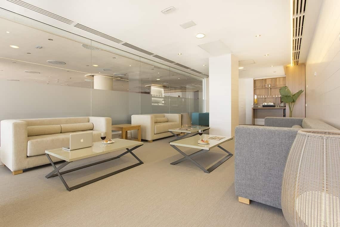 a waiting room with a couch and a laptop on a table