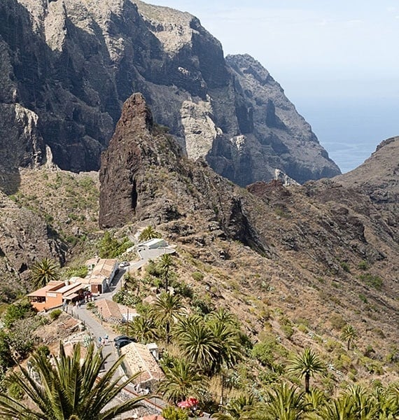 a small village sits on the side of a mountain