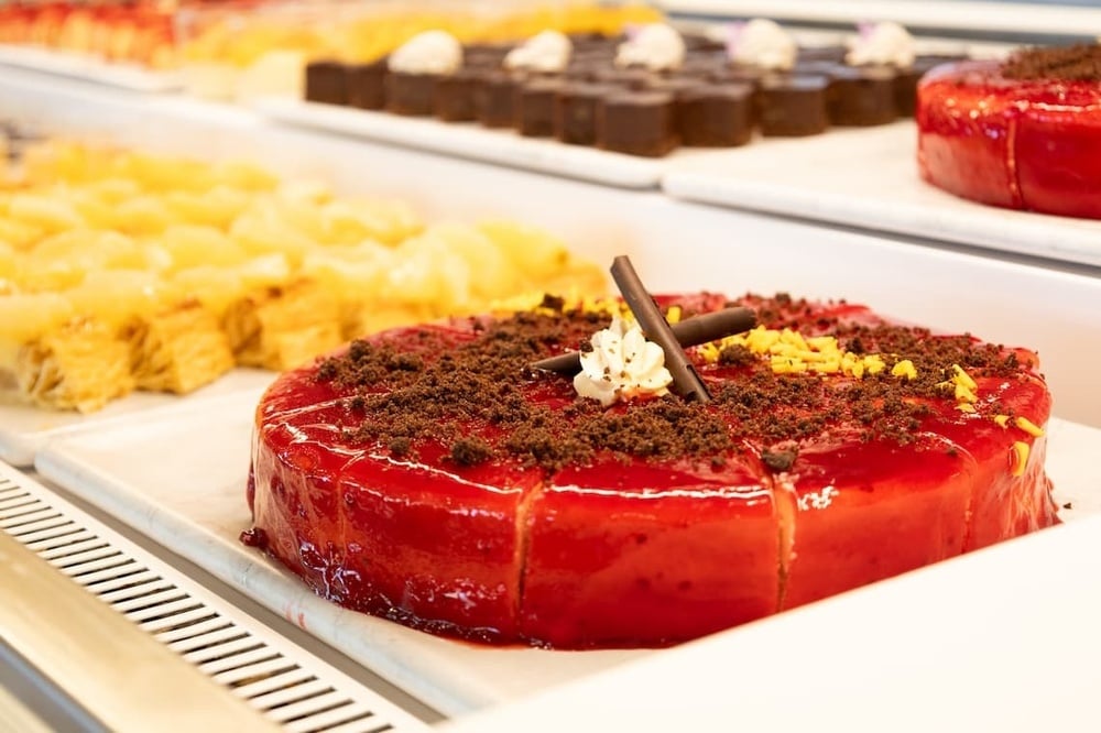 a red cake with chocolate crumbs on top of it