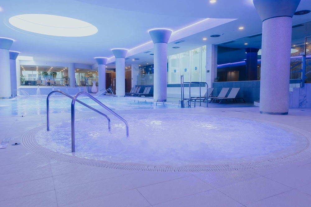 a large indoor swimming pool with stairs leading to it