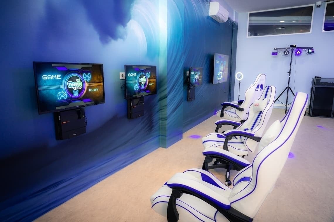 a row of chairs in front of a screen that says game on it
