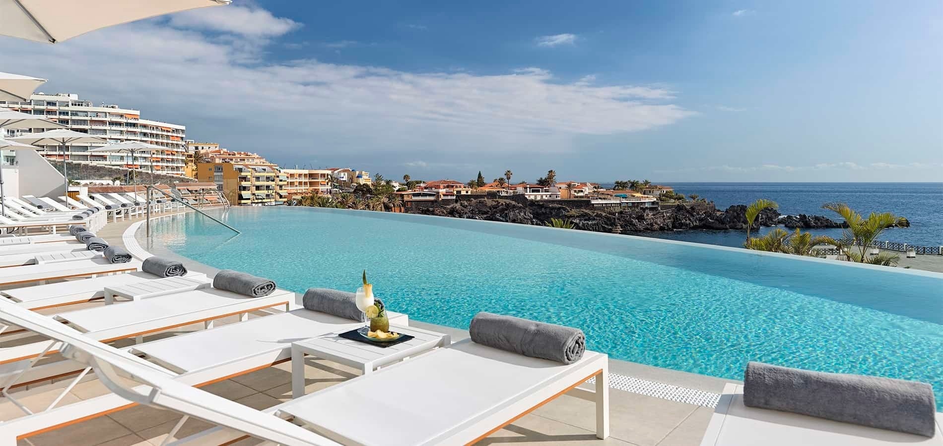 a large swimming pool with a view of the ocean