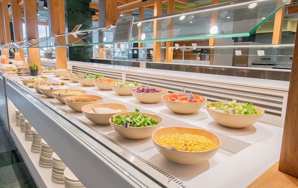 a buffet line with lots of bowls of food