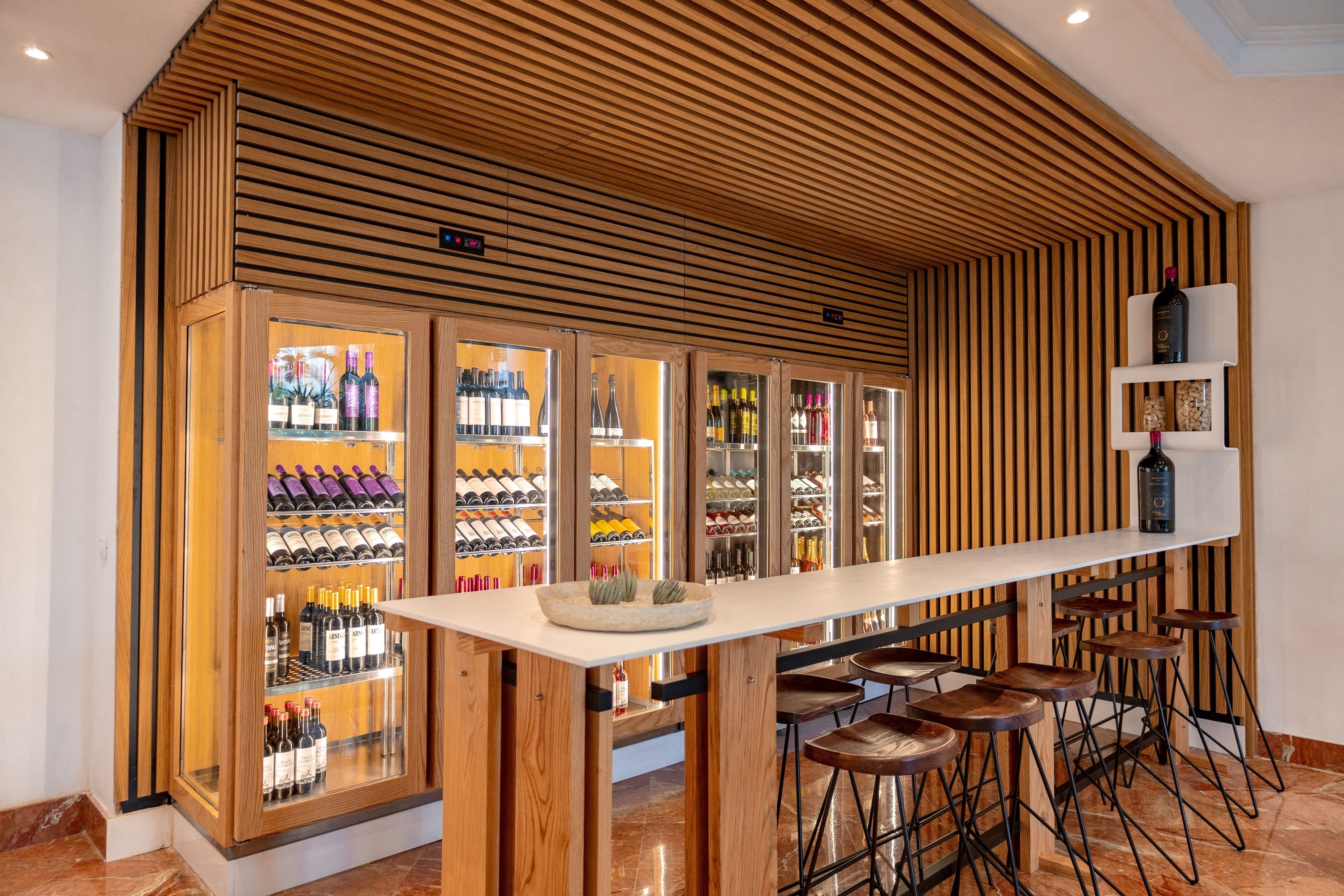 a wine cooler with bottles of wine including a bottle of aconcagua