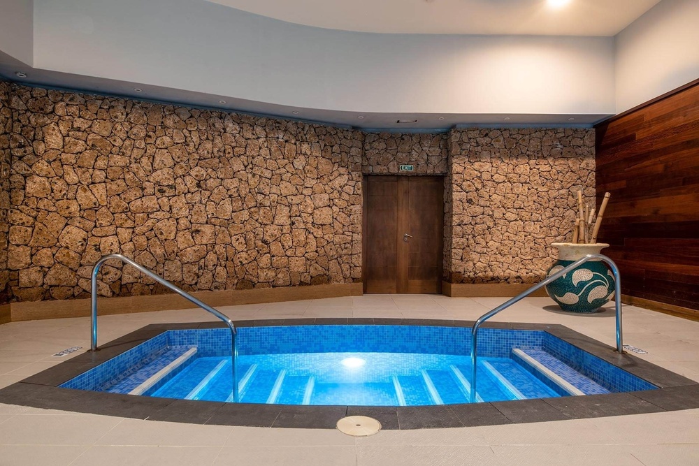 a swimming pool in a room with a sign that says exit