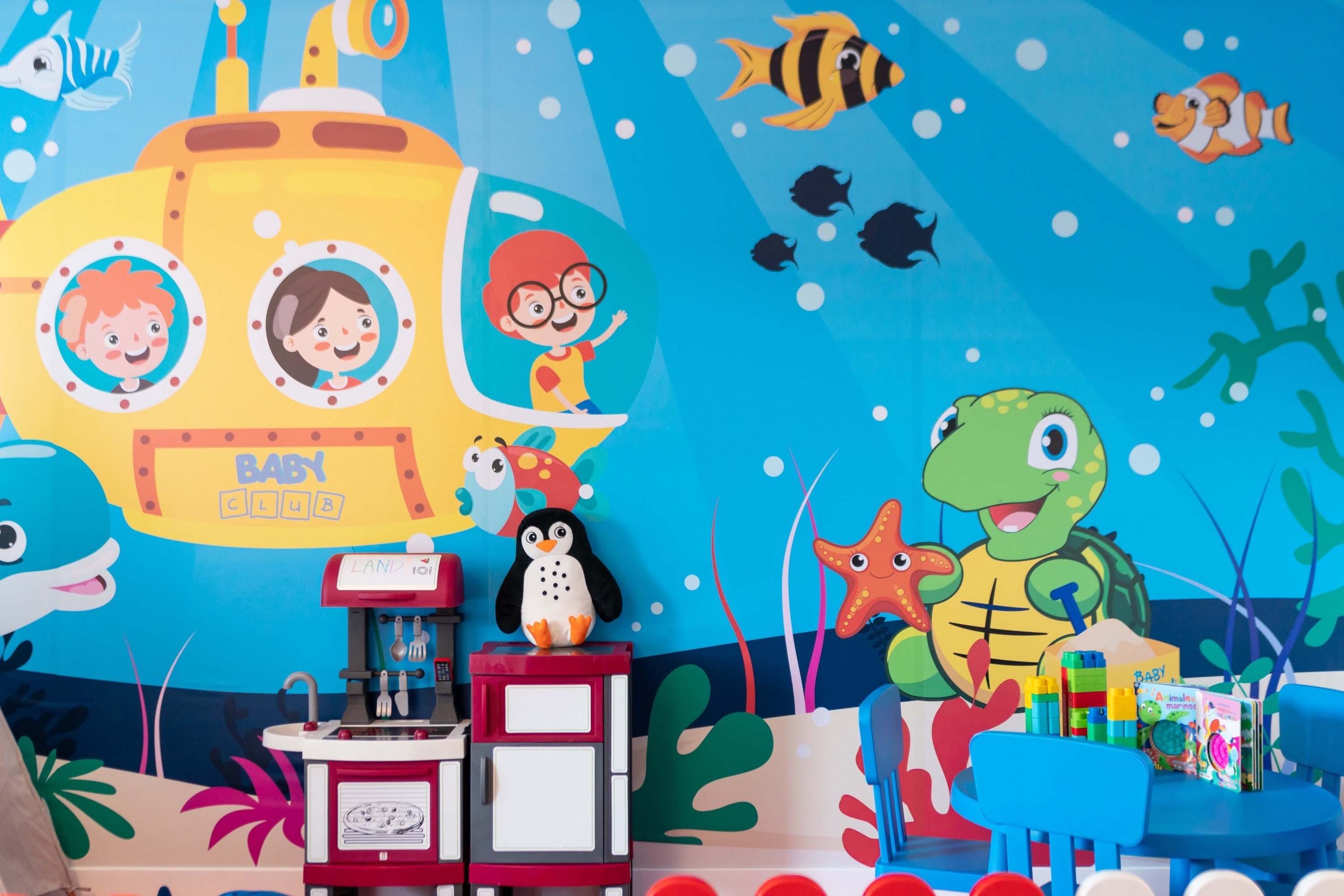 a room with a mural on the wall that says baby sea