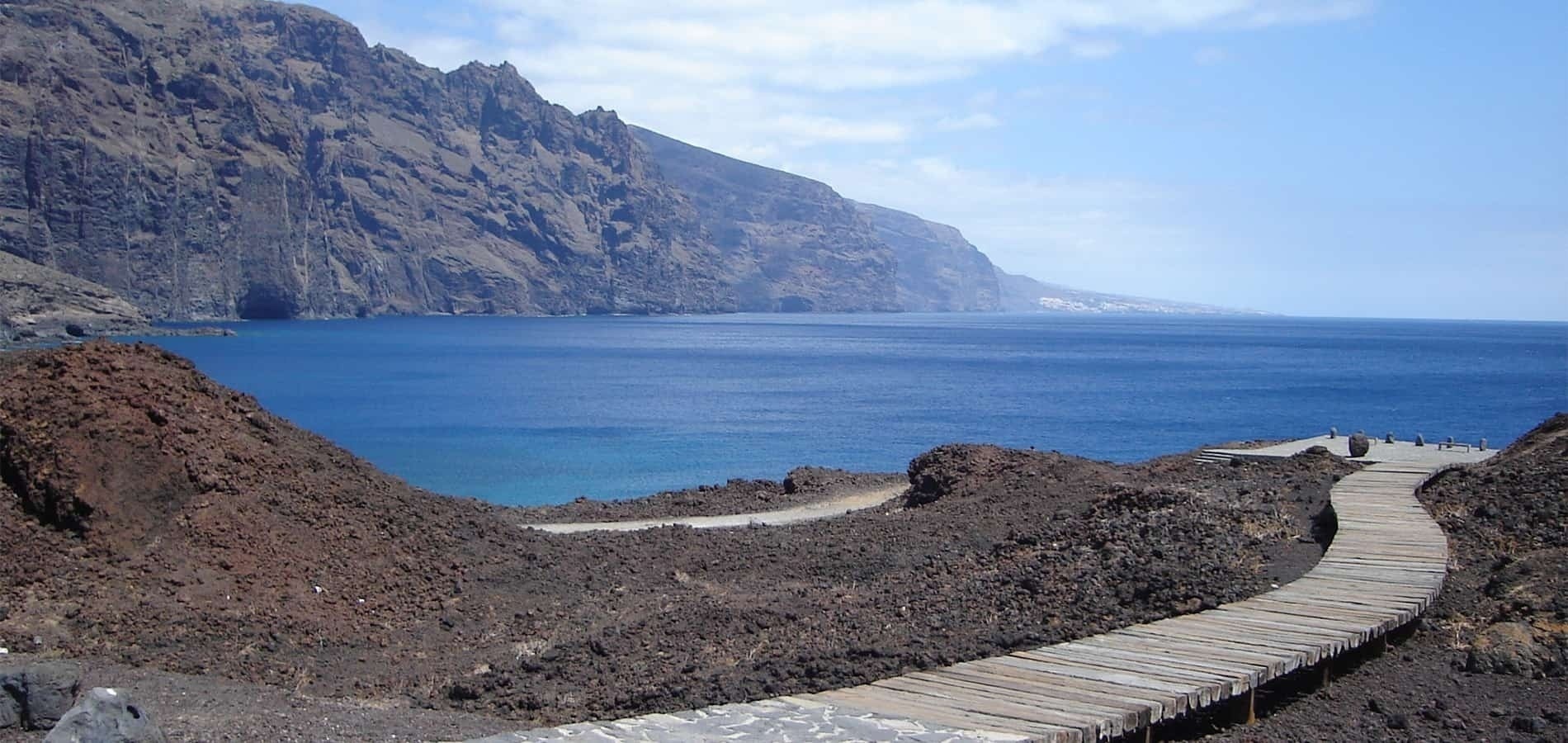 a wooden walkway leads to a large body of water