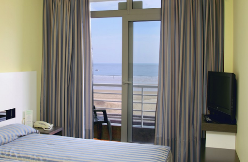a hotel room with a bed and a television