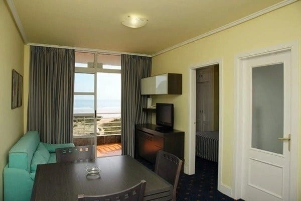 a room with a table and chairs and a television
