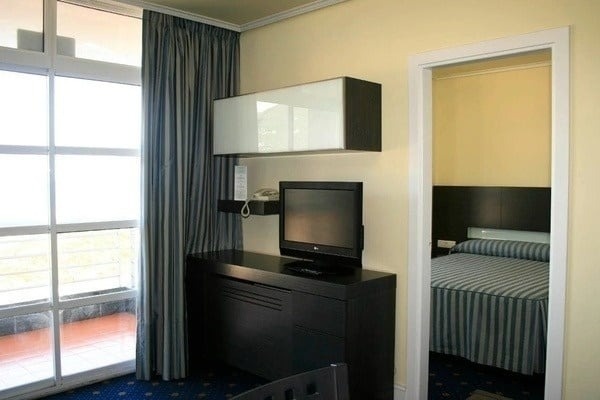 a room with a table and chairs and a television