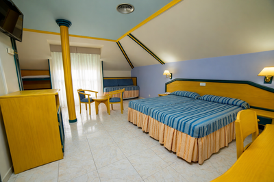 a hotel room with a table and chairs and a television