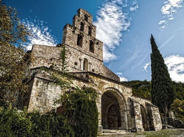 a large stone building with a blue sky in the background