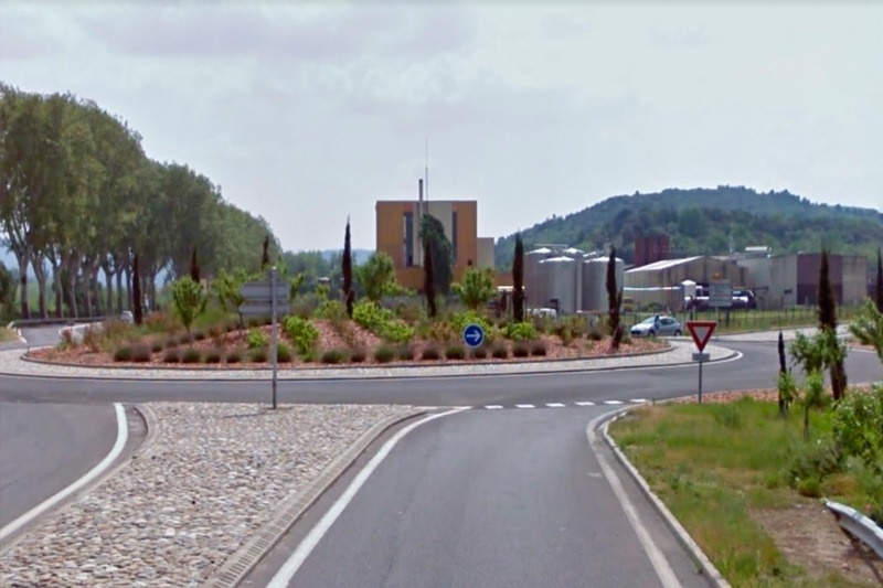 a roundabout with a sign that says v on it