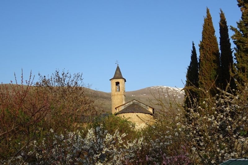 a church with a bell tower and a cross on top
