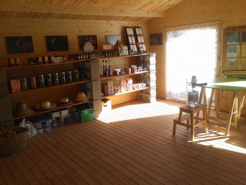a wooden room with a table and shelves full of items