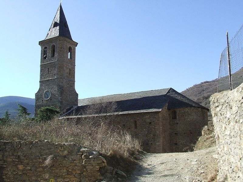 a stone building with a clock on the top of it