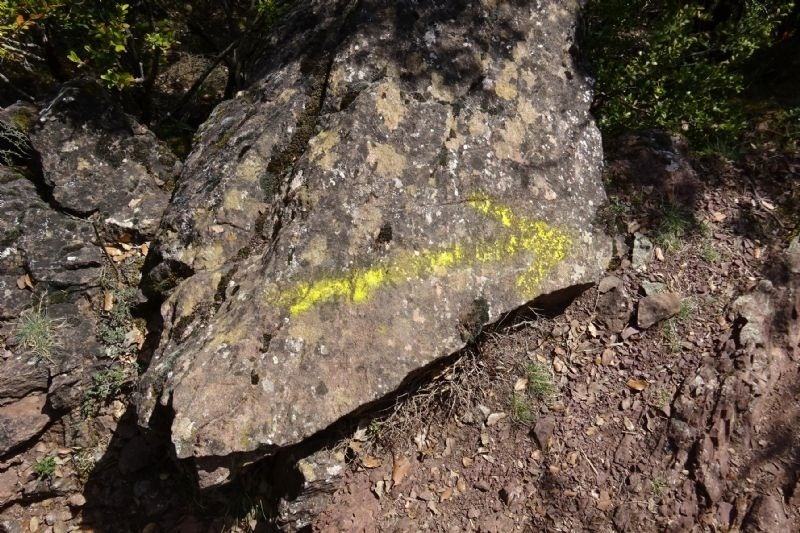 a large rock with a yellow line painted on it