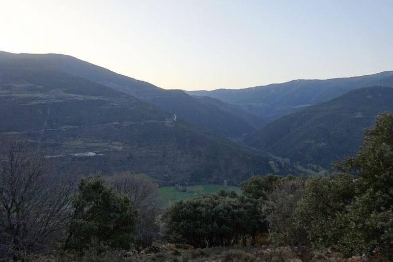 a view of a valley with mountains in the background