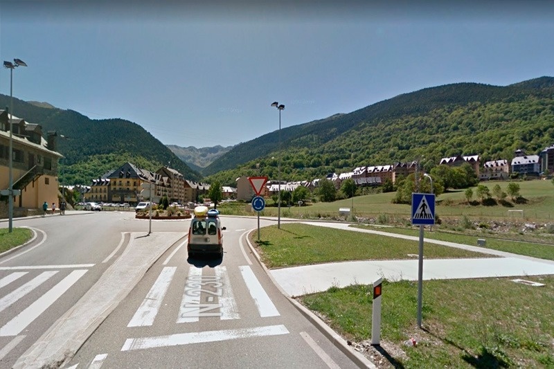 a white van is driving down a road with a sign that says n260